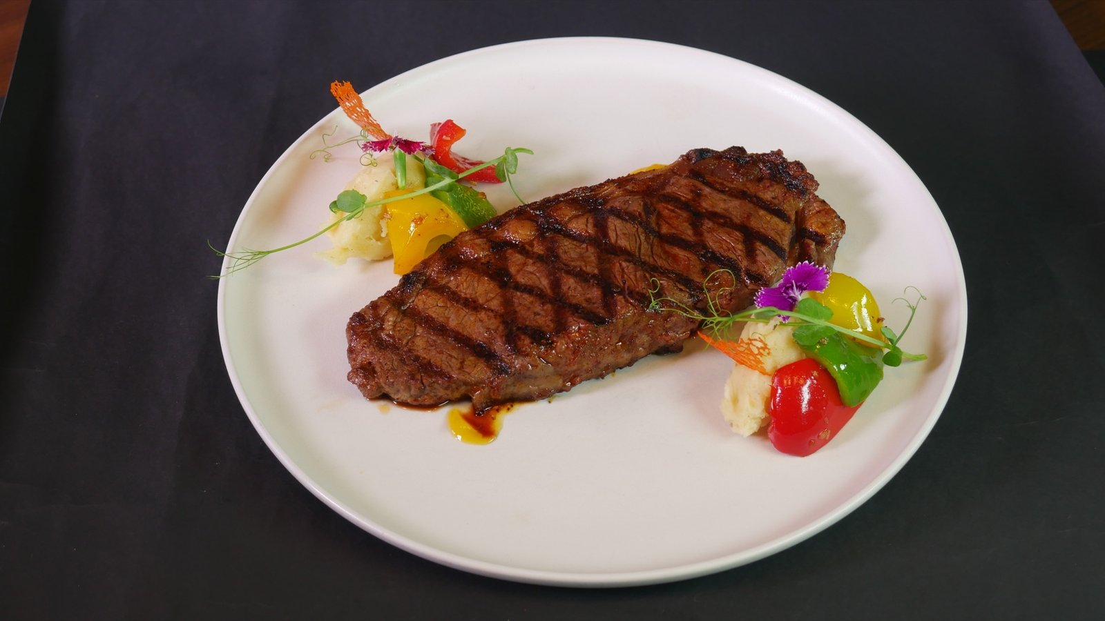 Angus steak served with mashed potato and fresh vegetables at Lambogrill
